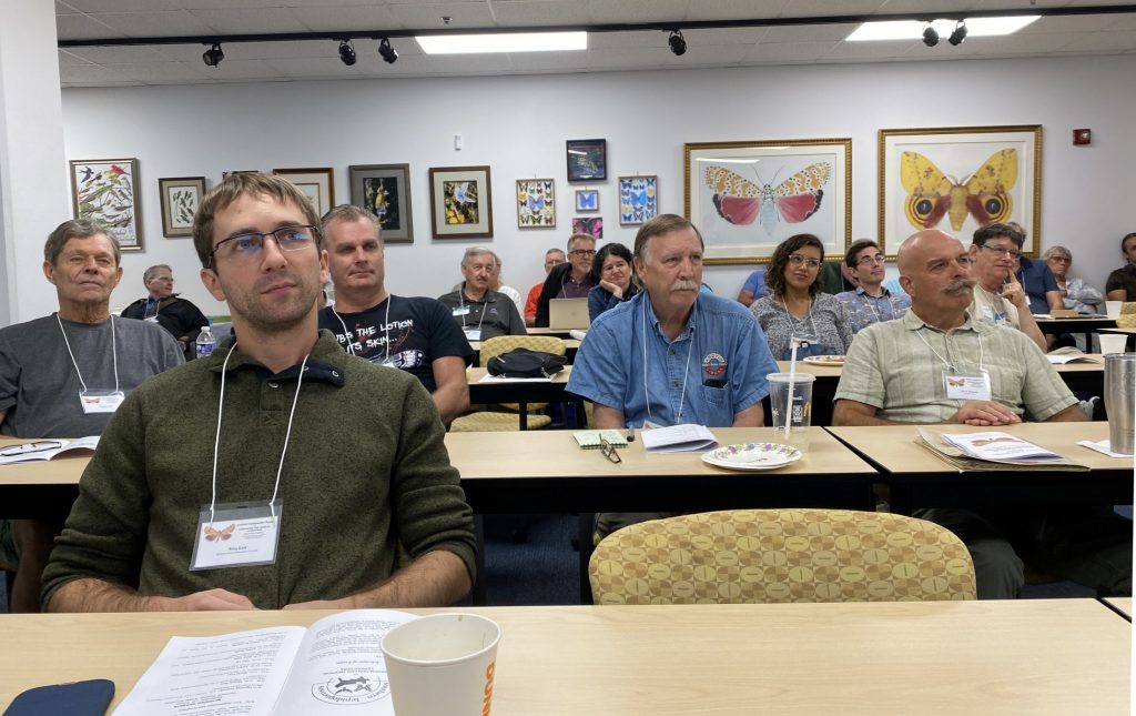 People in conference room watching a presentation.
